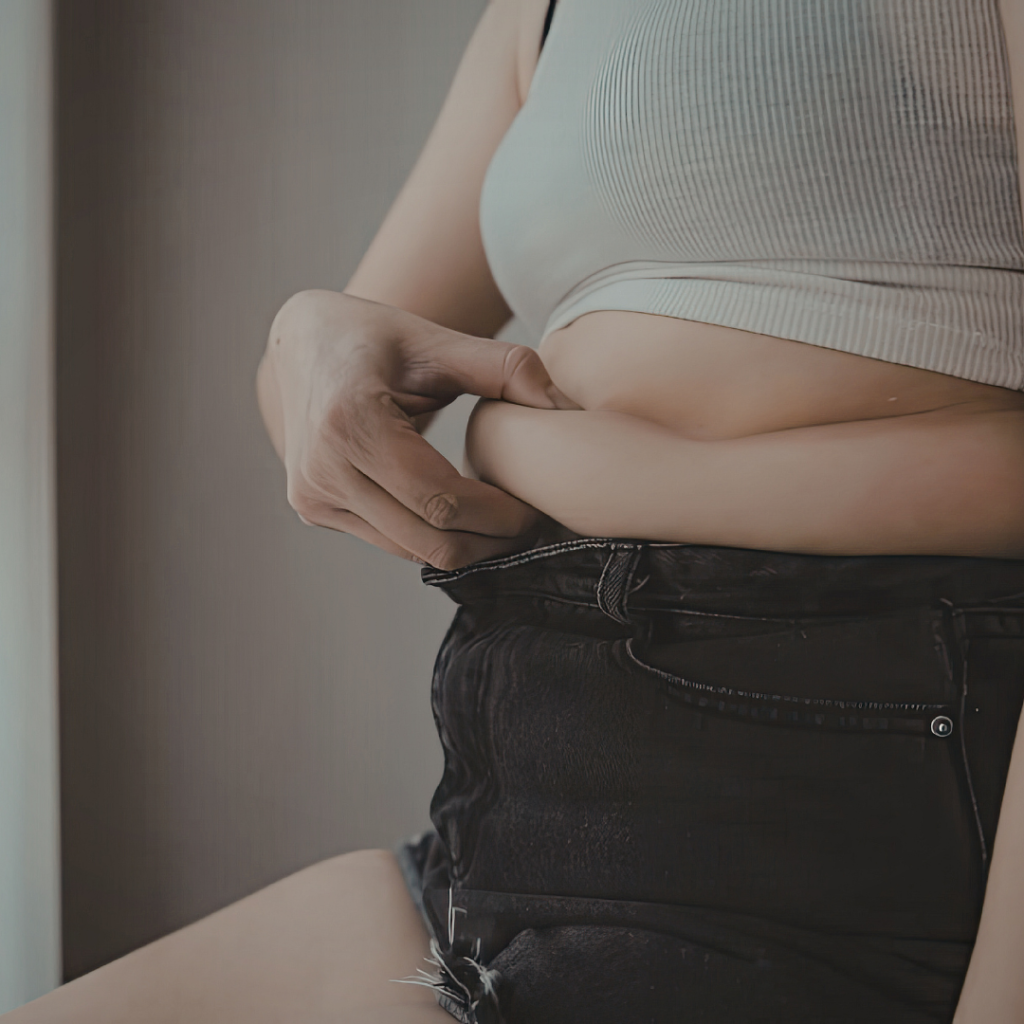 Woman after pregnancy during medical assessment to determine suitability for a mummy makeover procedure